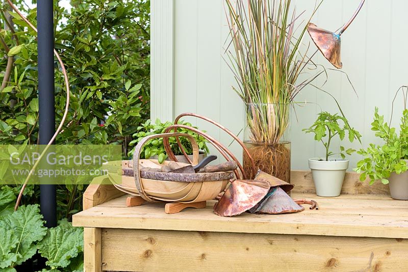 Potting bench with herbs and garden trug - 'The Perfumer's Garden', RHS Malvern Spring Festival, 2018. Sponsor: Keyscape Design