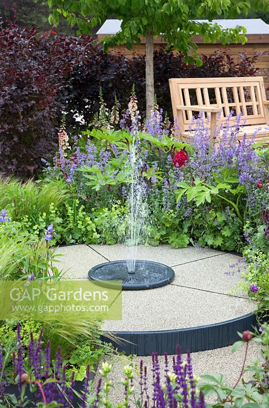 Circular fountain in show garden - 'A Family Garden', sponsored by CCLA, RHS Chatsworth Flower Show, 2018.

