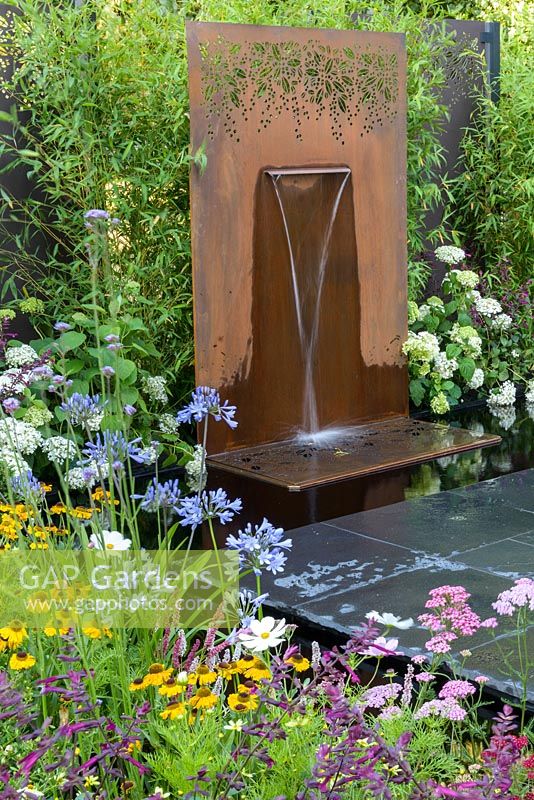 Modern water feature in show garden - Brilliance in Bloom, Sponsored by Stark and Greensmith, Simon Probyn Sculpture, Nickie Bonn and Art4Space, RHS Hampton Court Flower Show, 2018.