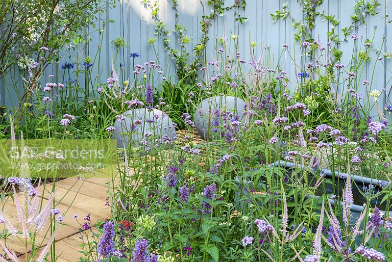 Wooden boards with seating area and perennials. Southend Young Offenders 'A Place to Think, RHS Hampton Flower Show, 2018 