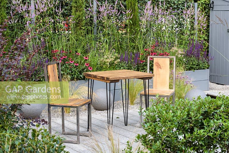Wood and metal table and chairs. 'Secured by Design', RHS Hampton Flower Show, 2018 