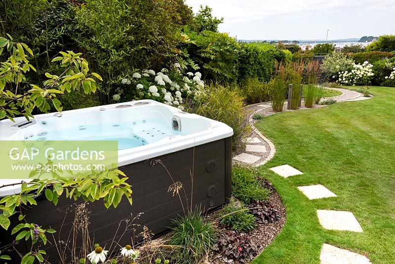 View of garden jacuzzi surrounding by planting.