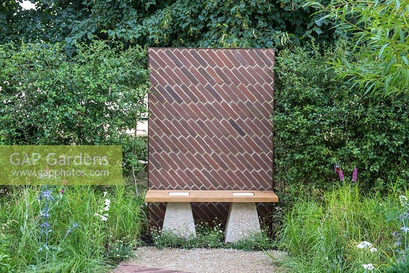 Bench next to a brick panel inspired by the arch on the underside of the Brunel railway bridge, Crataegus monogyna hedging  - The South Oxfordshire Landscape Garden, RHS Hampton Court Palace Flower Show 2018