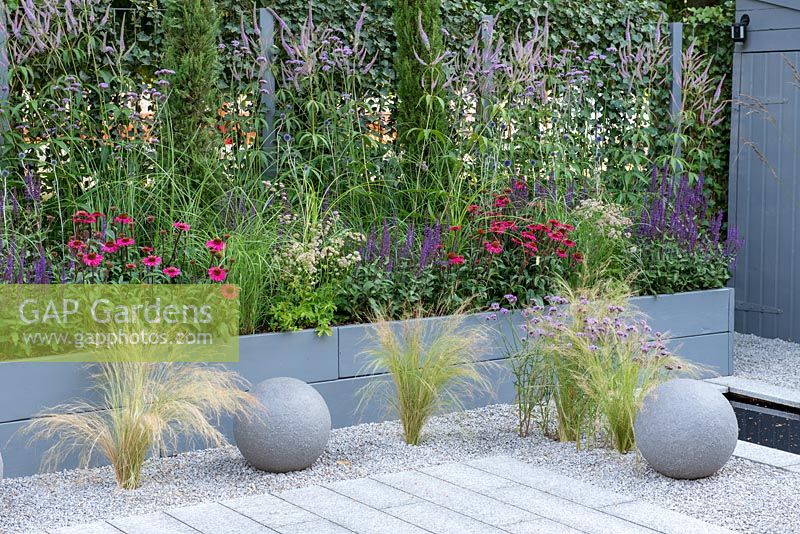 Blue painted raised border set in gravel with stone ball features - Secured by Design, RHS Hampton Court Palace Flower Show 2018