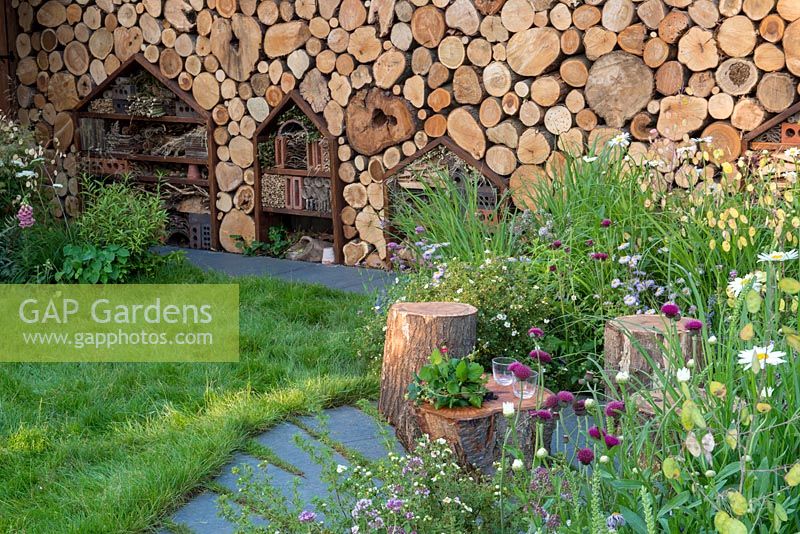 Insect habitat wall in wildlife-friendly garden - The Family Garden, Sponsored by Practicality Brown, Marshalls, The Tree Company, RHS Hampton Court Palace Flower Show, 2018.
