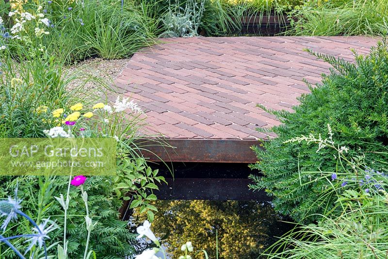 Brick paving over a stream - The South Oxfordshire Landscape Garden, RHS Hampton Court Palace Flower Show, 2018.
