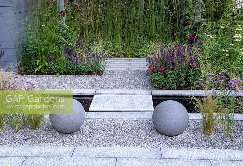 Paving over water rill, gravel planted with Stipa tenuissima and Verbena bonariensis - Secured by Design, sponsored by Secured By Design, Capel Manor College, Smartwater, RHS Hampton Court Palace Flower Show, 2018.