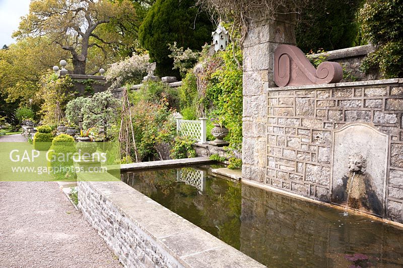 Pool with lion's head water spout in the Sunken Garden. Holker Hall, Grange over Sands, Cumbria, UK. 