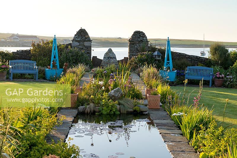 View of coastal garden with 18-metre long rill edged with Iris.