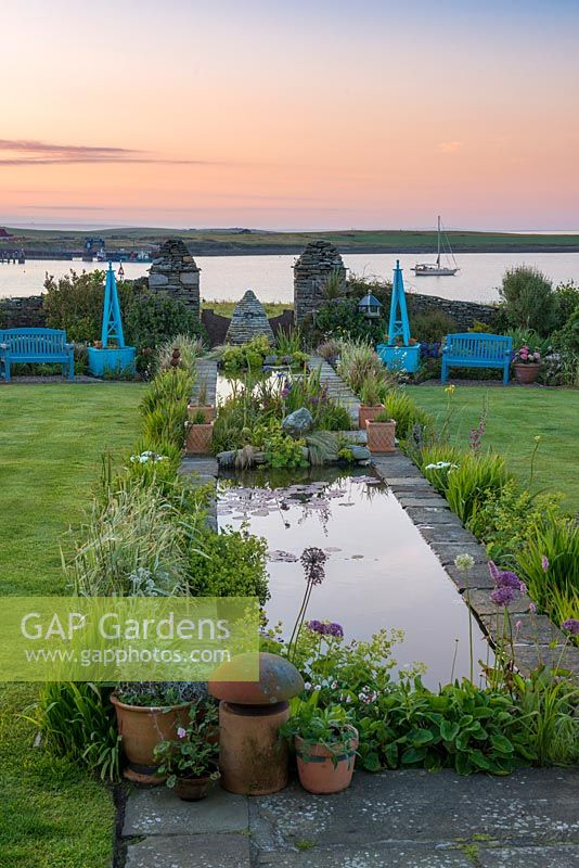Dawn breaks over the coastal garden at Quoy of Houton, Orkney, unveiling an 18-metre-long rill. 
