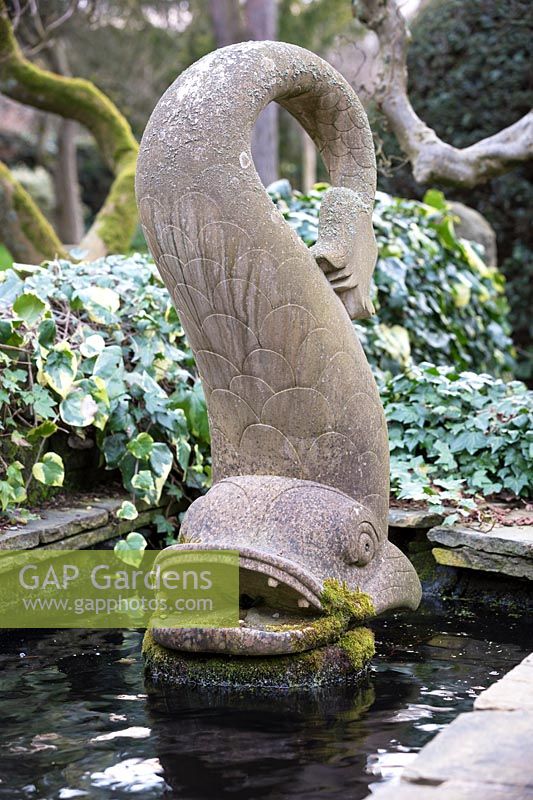 Fish sculpture in pond. York Gate Garden, Leeds