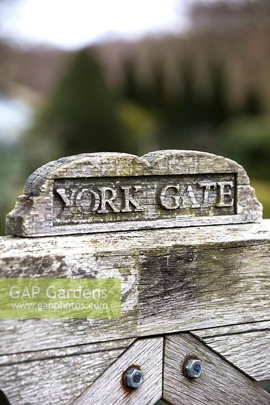 Engraved wooden gate at York Gate garden, Leeds, UK.