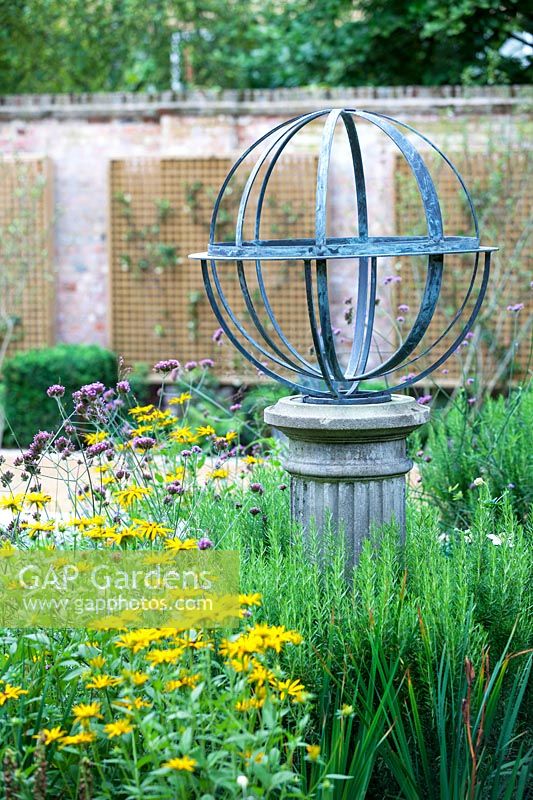Armillary Sundial in mixed bed. Garden Design by Peter Reader Landscapes.
