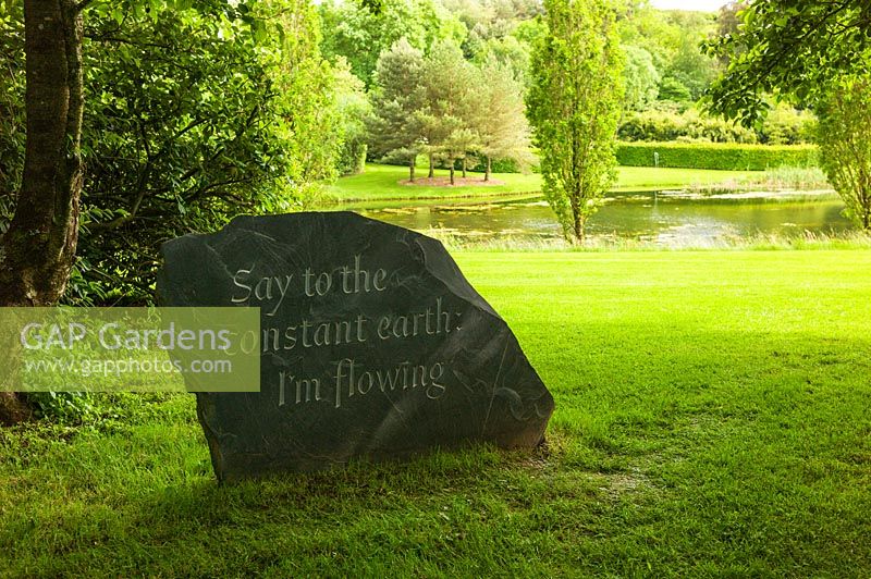 Slate stone carved with quotation from the poet Rilke. Plaz Metaxu Garden, Devon, UK. 