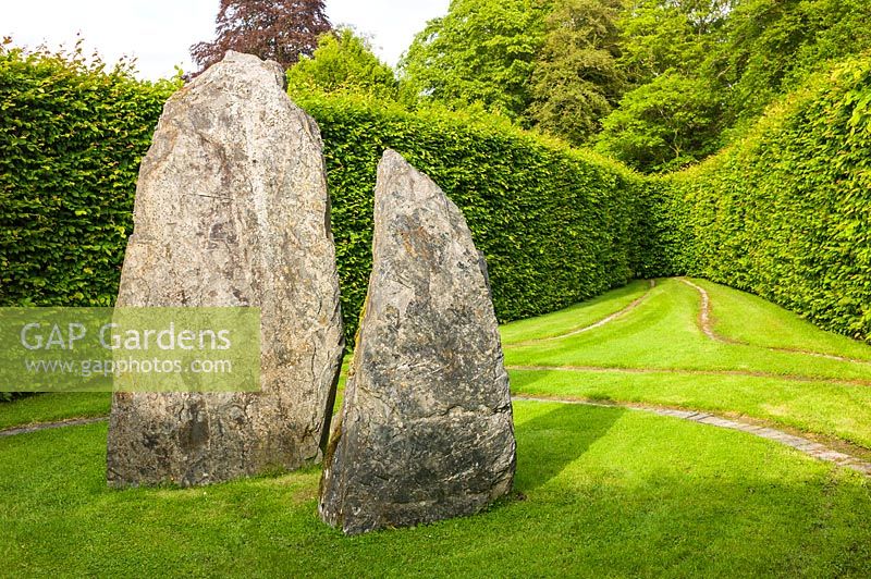 Delabole slate standing stones within a Hornbeam hedge enclosure. Plaz Metaxu Garden, Devon, UK.