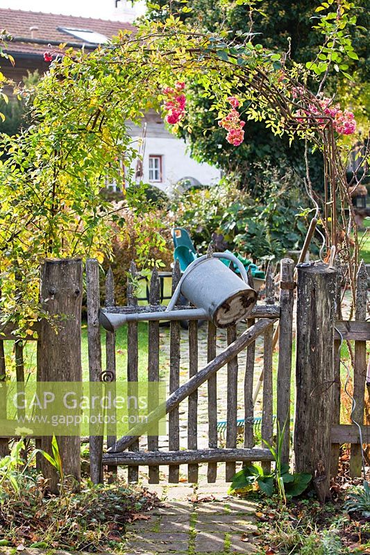 Garden gate with watering can.