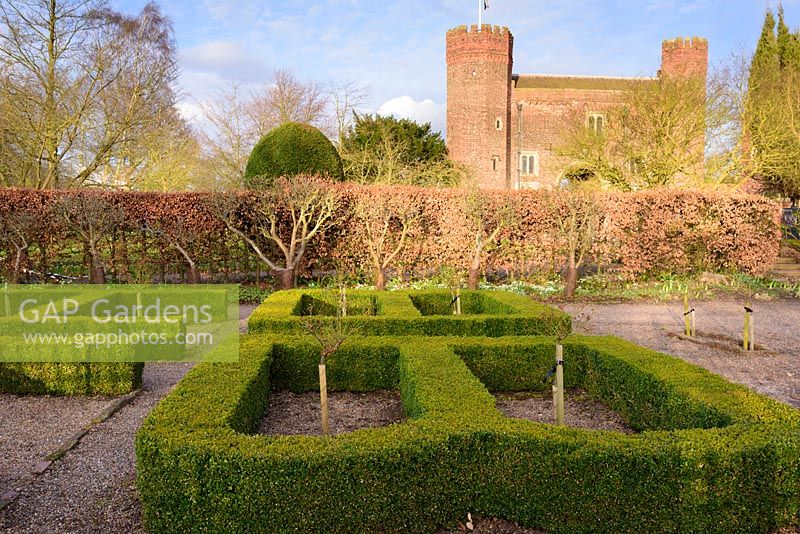 Box parterre with standard roses and gatehoue at Hodsock Priory, Blyth, Nottinghamshire