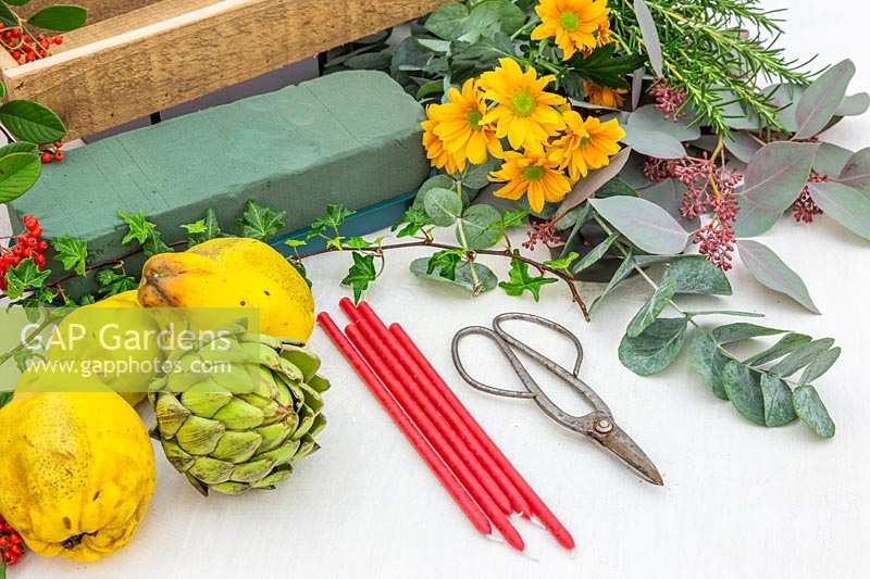 Tools and materials for creating autumnal floral candle arrangement.