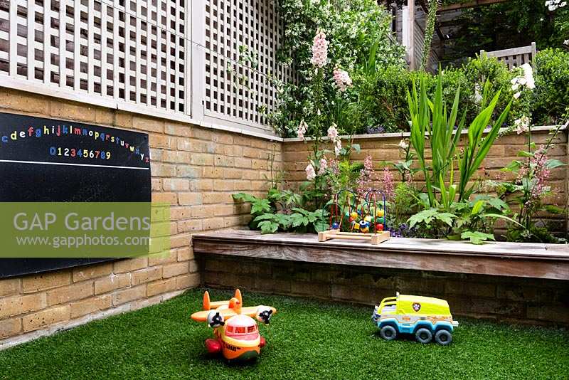 Family friendly garden with childrens toys, built in bench and blackboard