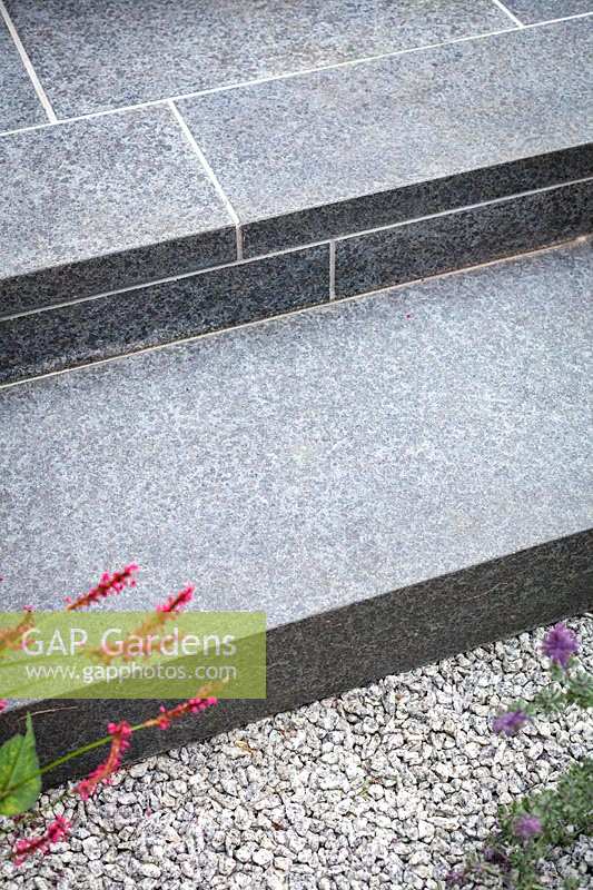 Steps in hard wearing black basalt tiles. Garden Design by John Davies.