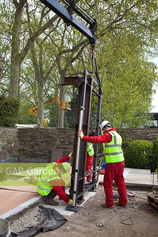 Pavilion parts are lowered into place in preparation for RHS Chelsea Flower Show