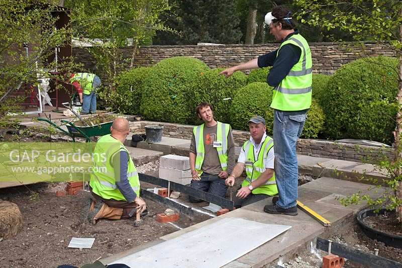 Tom Stuart-Smith with construction team in preparation for RHS Chelsea Flower Show. 