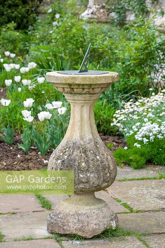 Sun dial and white flowering borders, Sudeley Castle, Gloucestershire, UK.
