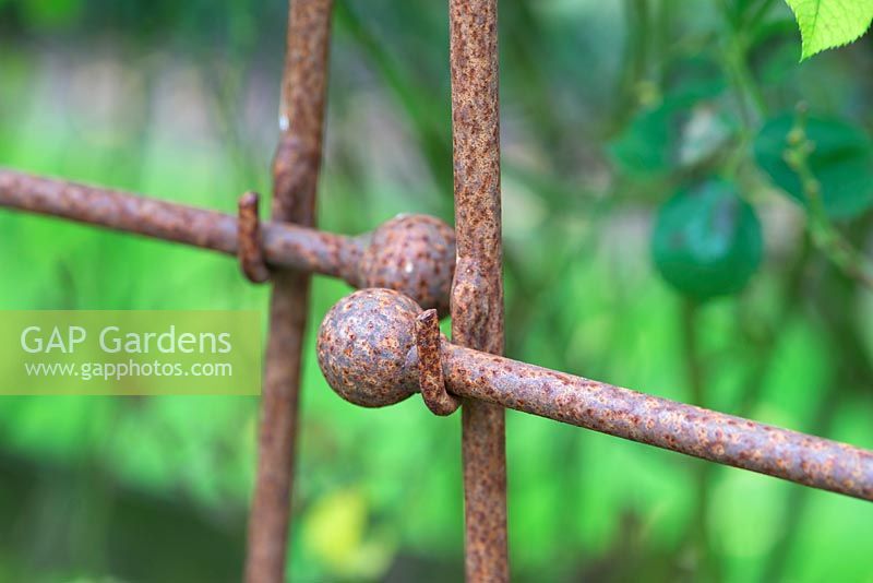 Rusted metal supports with ball ends. 