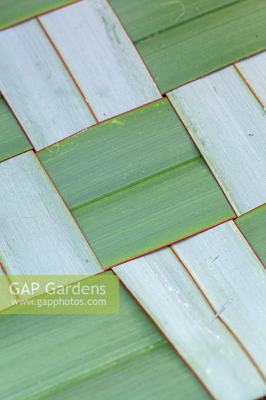 Close up of woven table mat made from Phormium leaves.