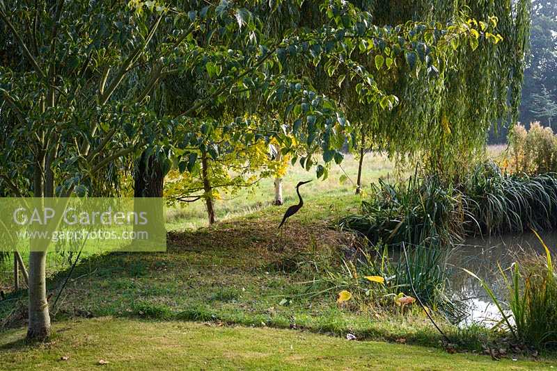 Sculpture of Heron near pond - Thundridge Hill House Garden, Hertfordshire, UK