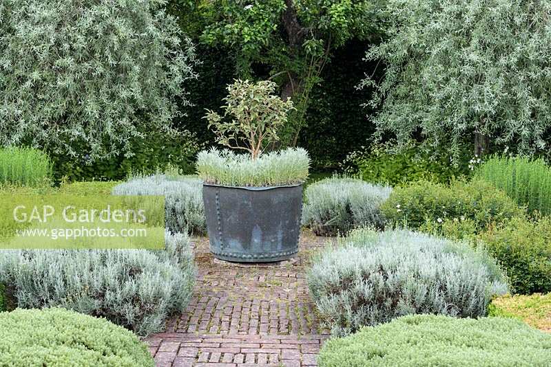 Grey  and  White Garden featuring metal planer in drought-resistant  planting scheme
