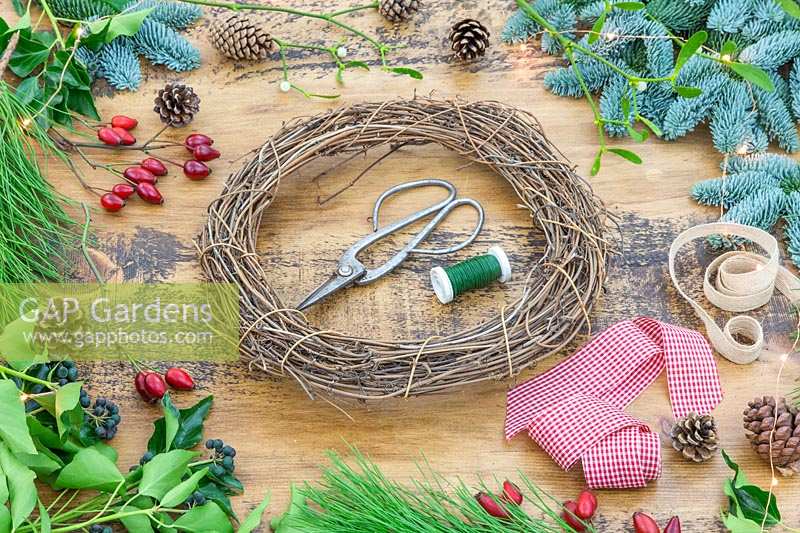 Tools and materials to make decorative Christmas wreath.