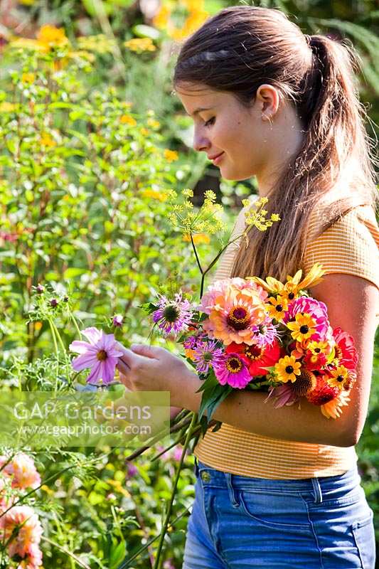 Girl picking flowers for floral arrangements.