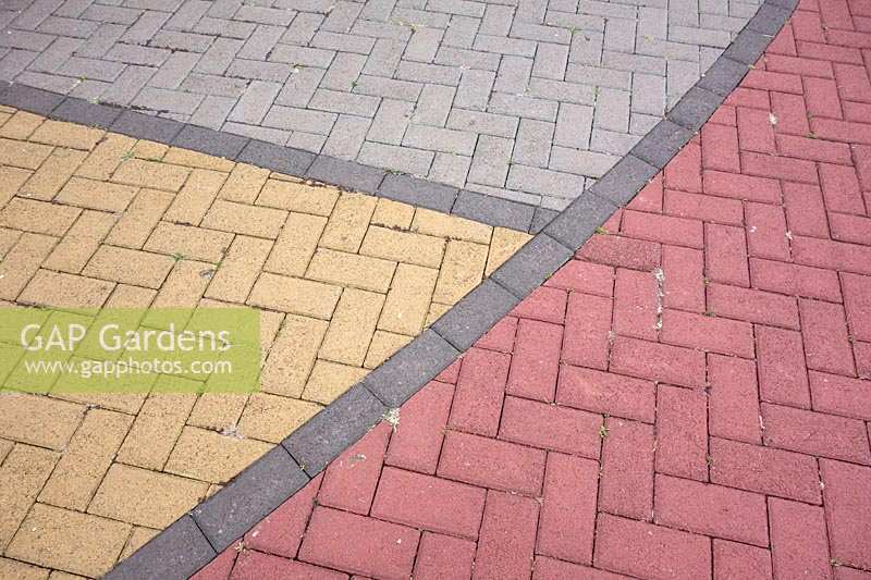 Patterned paving made from different coloured bricks