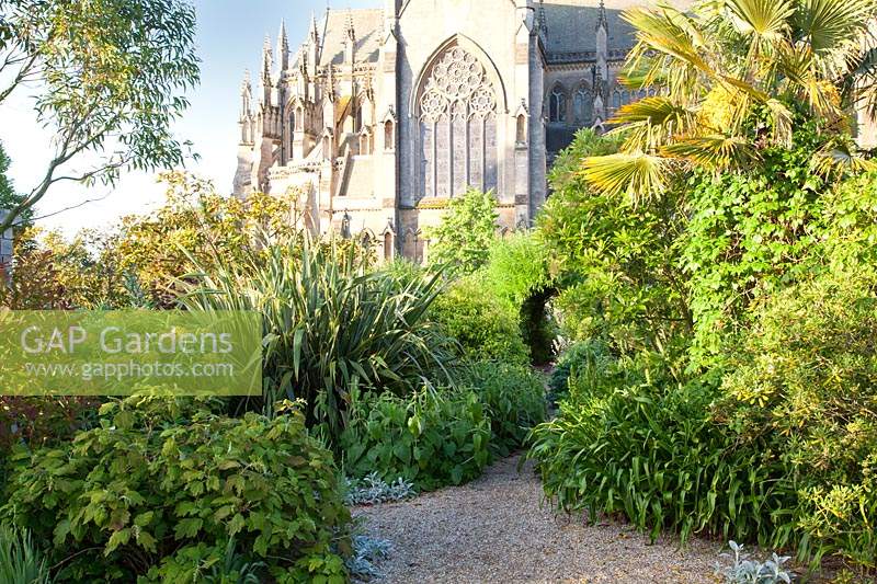 Pathway in walled garden with Cathedral beyond. Arundel Castle, West Sussex, UK. 
