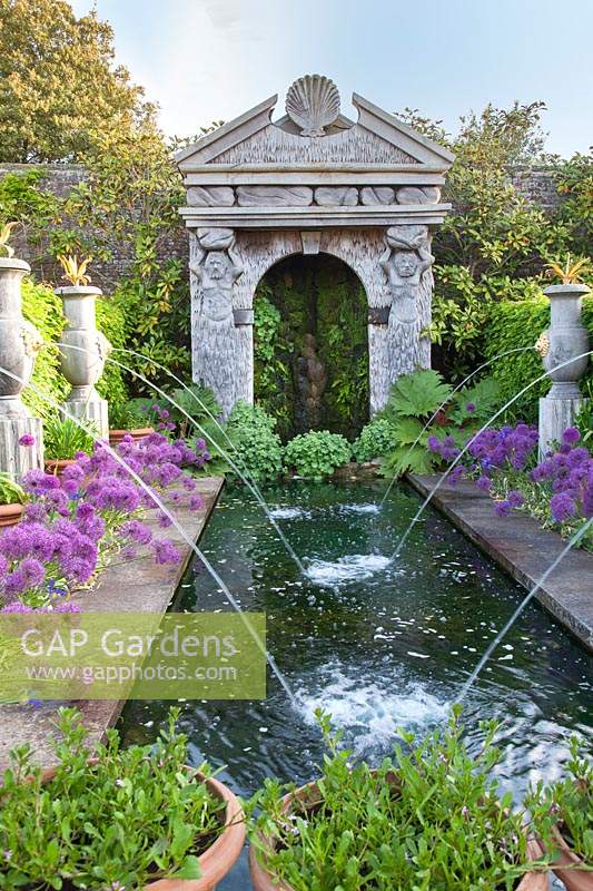Italianate water fountains and pool with Alliums 