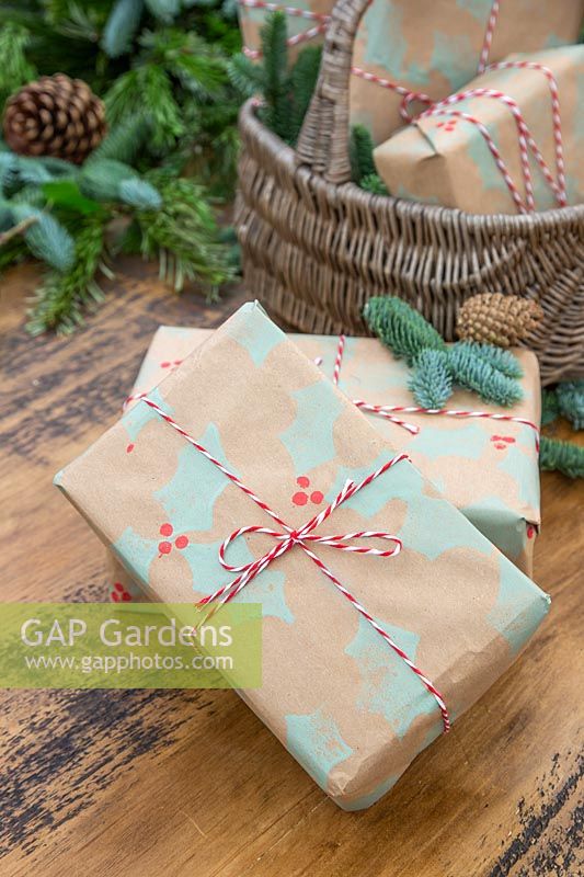 Pile of christmas gifts wrapped with handmade craft wrapping paper.