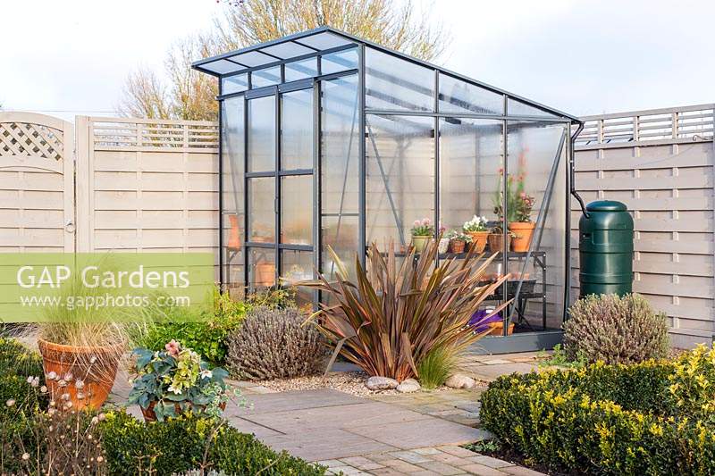 View of small greenhouse in modern garden.