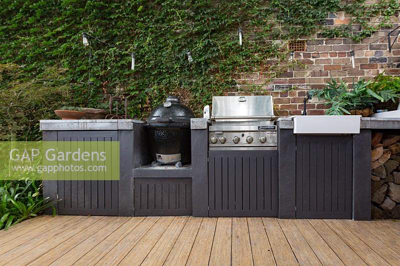 View of outdoor cooking area on terrace patio, with barbecues and sink. 