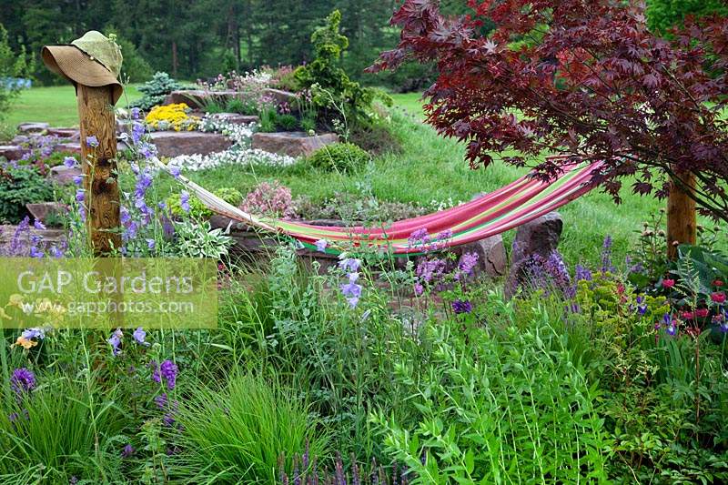 Just Add Water show garden with hammock above perennial planting