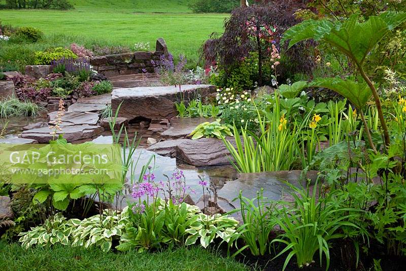 Just Add Water show garden - view across pond with nearby planting and rocks