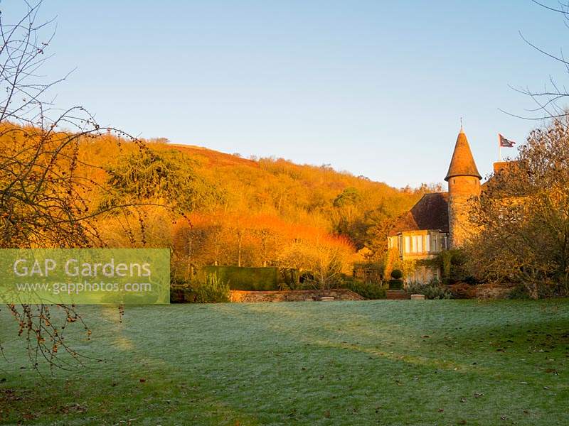 Little Malvern Court, surrounded by late autumn colour from the Malvern hills woodland. 
