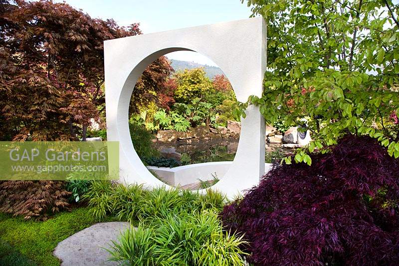 View through circular opening in square sculpure in the 
'At One With... A Meditation Garden' show garden