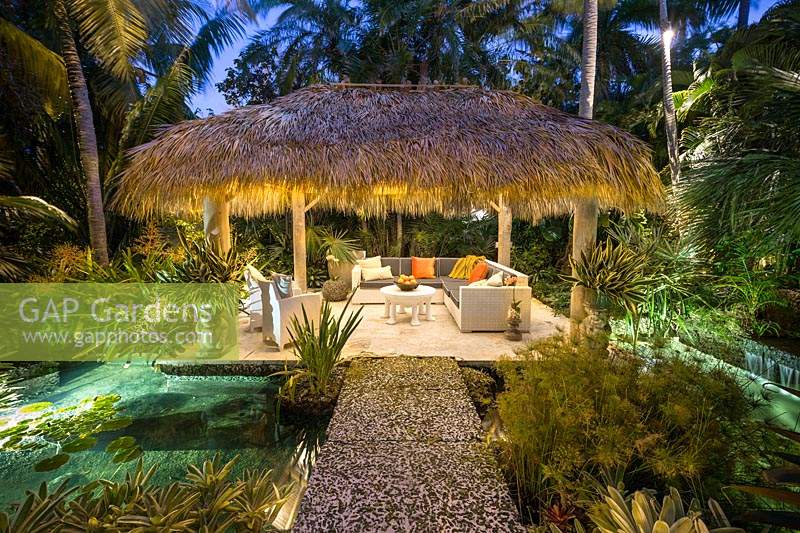 The chickee hut with seating and cushions. The Jones Residence, Key West, Florida, USA. Garden design by Craig Reynolds.
