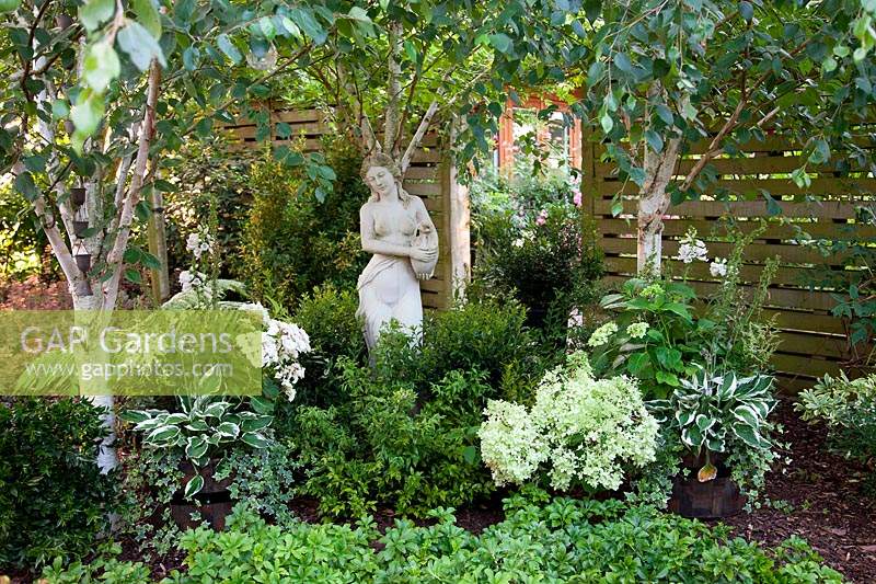 Classic statue in The shade garden, in garden of designer Karen Tatlow, Lichfield. 