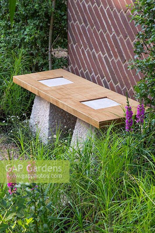 Bench topped with Scottish oak with staddle stones and brick screen in 
'South Oxfordshire Landscape Garden'
