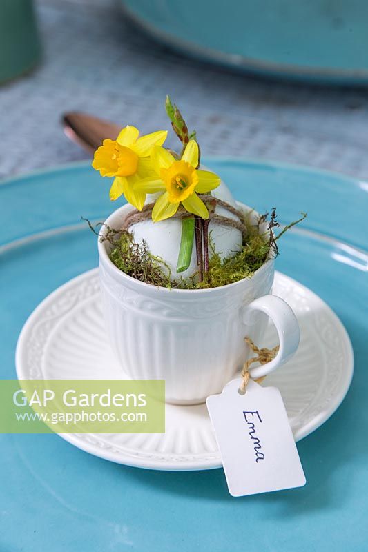 Cup and saucer with decorated egg and name tag