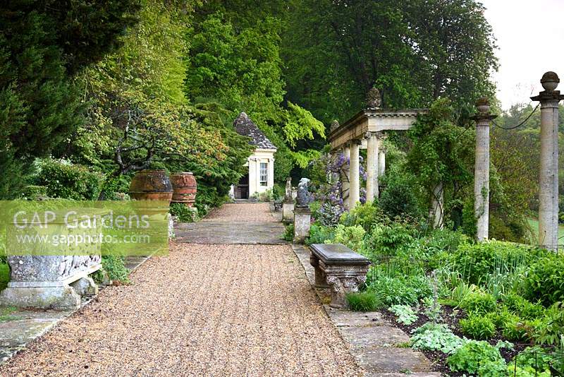 The Great Terrace with stone colonnade, Wisteria and statuary at Iford Manor, Bradford-on-Avon, Wiltshire, UK.  