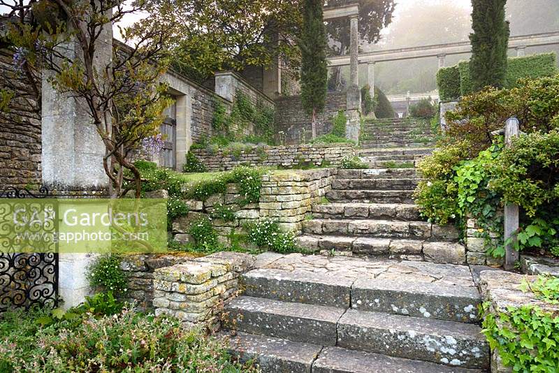 Steps lead up the terraced garden at Iford Manor, Bradford-on-Avon, Wiltshire, UK. 