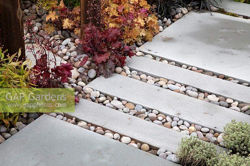 Paving interspersed with pebbles in 'A Glimpse of South East Asia' garden at BBC Gardeners World Live 2019